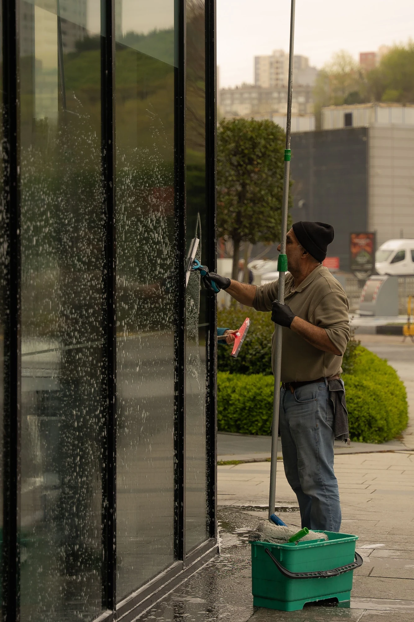 Illustrative photo of window glass being cleaned with a squeegee